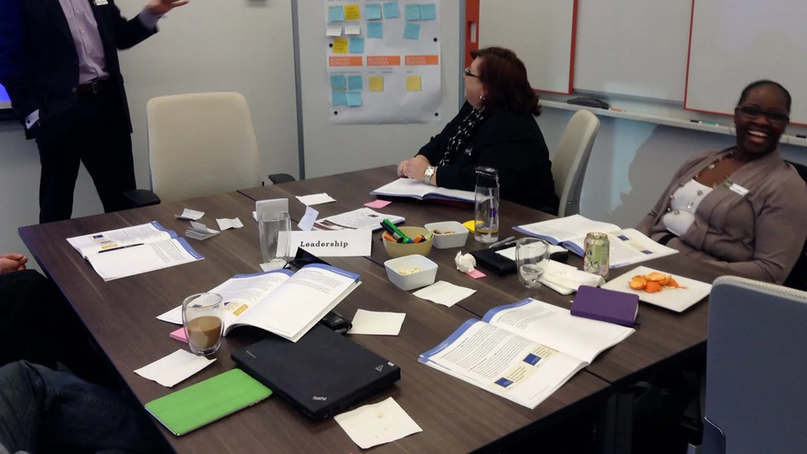 Small group of employees in a meeting room during an annual compliance training session