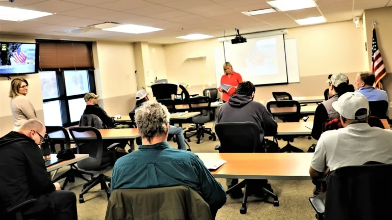 New hires in a meeting room during custom corporate employee onboarding training led by a facilitator