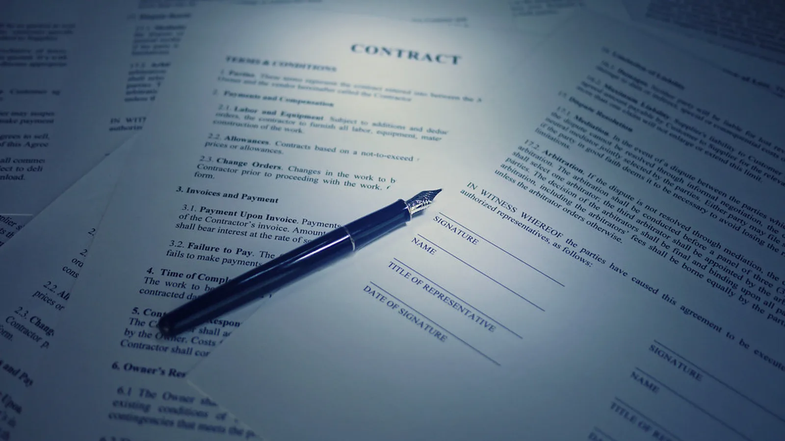 Employment forms and a pen on a desk representing the onboarding paperwork lane.